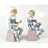 LLADRÓ; a pair of harlequins, one playing a lute, each seated on alphabetical plinth, height 21.