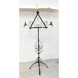 A wrought iron free standing three-branc