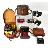 A collection of cameras and binoculars t