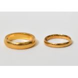 A 22ct yellow gold wedding band, size O and a further 22ct yellow gold example, size L/M,