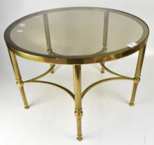 A contemporary circular brass table with