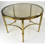 A contemporary circular brass table with