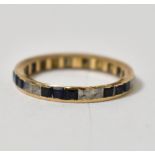 A yellow metal eternity ring with pavé