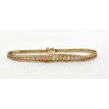 A 9ct gold semi-rigid bracelet with elon