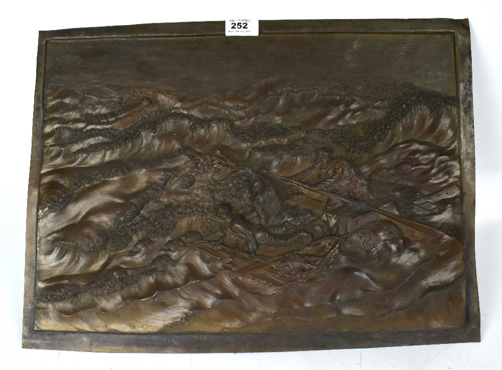 A 19th century embossed copper plaque depicting stormy seas with three figures on a life raft to