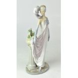 LLADRÓ; a figure of a young lady wearing 1920s evening attire, height 34cm.