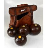 A set of four bowling balls in brown fau