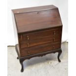 An early 20th century walnut fall front bureau with an assortment of pigeon holes and single drawer
