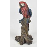 A small 19th century cold painted bronze figure depicting a colourful parrot perched on a branch,