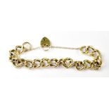 A 9ct yellow gold link bracelet with heart padlock and three extra links, combined approx 25.7g.