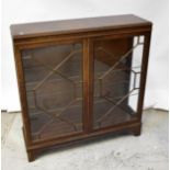 A reproduction mahogany display cabinet, the moulded top above a pair of astragal glazed doors,
