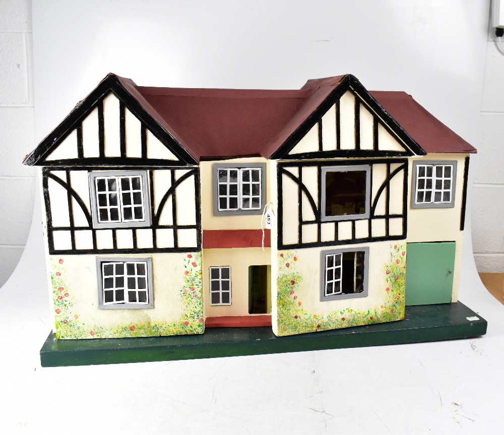 TRI-ANG; a double fronted Tudor two-storey style dolls' house with additional garage,