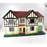 TRI-ANG; a double fronted Tudor two-storey style dolls' house with additional garage,