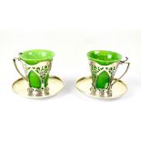 WITHDRAWN A pair of Edward VII hallmarked silver Art Nouveau cup holders and saucers, diameter 8.