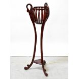 A contemporary mahogany torchère basket stand,