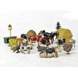 A quantity of early 20th century metal toys and miniature farm animals, to include beehive, cows,