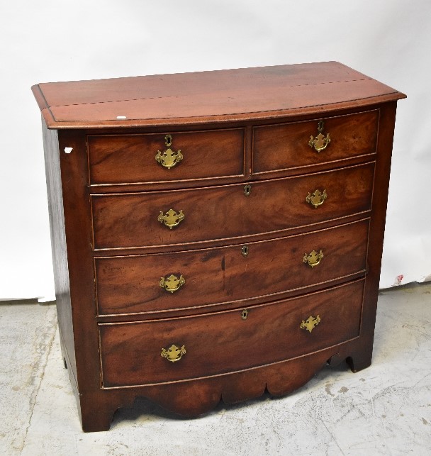 A Victorian mahogany bow front chest of two short over three long drawers, raised on bracket feet,