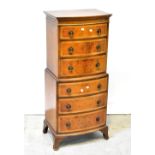 A reproduction mahogany and burr walnut bow front chest-on-chest of small proportions,