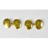 A pair of 18ct gold oval cufflinks, both engraved with indistinct initials,