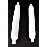 Two 19th century opaque white blow moulded glass rolling pins, with remnants of painted decoration,