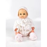 A 20th century realistically weighted baby doll, with open-and-shut blue eyes,