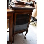 An early 20th century inlaid walnut display cabinet of small proportions,
