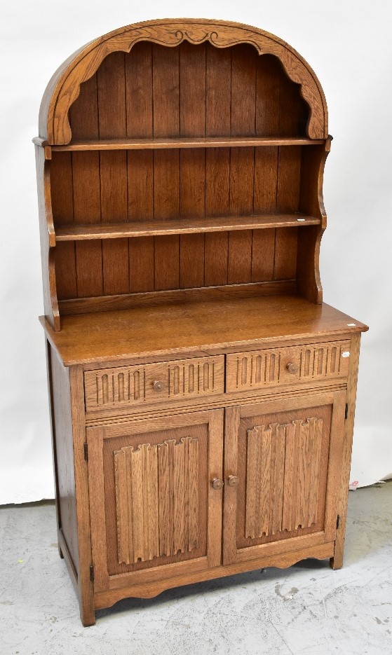 A reproduction oak dresser of small proportions,