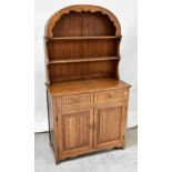 A reproduction oak dresser of small proportions,