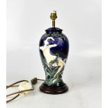 In the style of Moorcroft, a ceramic baluster lamp,