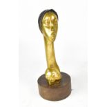 A contemporary brass bust of a young Ethiopian woman, on a circular hardwood plinth,