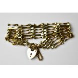 A 9ct gold six bar gate bracelet united by a 9ct gold heart-shaped padlock clasp,