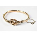 A Victorian-style beaded knot hollow tubular hinged bracelet with safety chain,