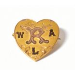 An Edwardian 9ct gold heart-shaped brooch, inscribed with initials W, R, A and L,