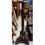 A contemporary ornately carved torchere stand,