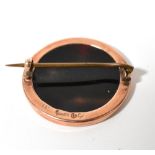 A 19th century circular brooch with tortoiseshell back,