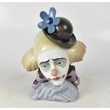 LLADRÓ; a ceramic head and shoulders bust of a clown with a blue flower in his hat, height 27cm.