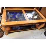 A large contemporary coffee table, the top set with two bevelled glass square panels,
