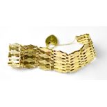 A 9ct gold fancy gate bracelet with seven-lozenge shaped bars,