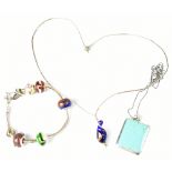 A sterling silver charm bracelet and two sterling silver necklaces to include one example set with