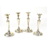 A set of four George III hallmarked silver table candlesticks,