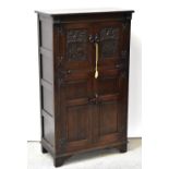 A reproduction oak cocktail cabinet,