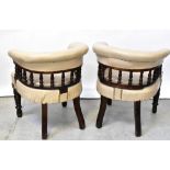 A pair of Victorian walnut framed bow back library chairs upholstered in beige leatherette with