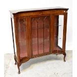 An Edwardian mahogany inverted bow front display cabinet with single glazed door,