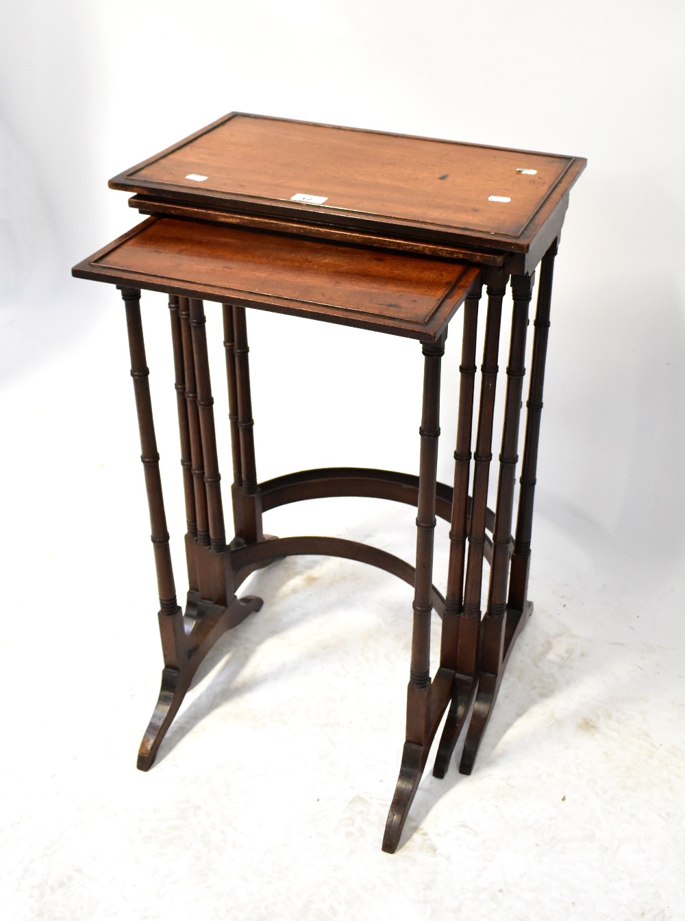 An early 20th century mahogany nest of three tables to faux bamboo supports and curved - Image 2 of 2