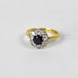 An 18ct yellow gold floral set dress ring with central sapphire and diamond surround, approx 2.6g.