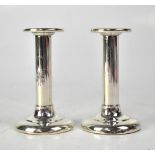 A pair of hallmarked silver loaded candlesticks with incised laurel wreath decoration, height 13.
