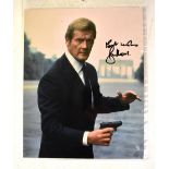 ROGER MOORE; a colour photograph bearing his signature, 25 x 22.5cm.