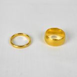 Two 22ct gold wedding bands, the wide band size O, the smaller cushion band size L,