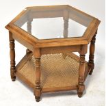 A contemporary mahogany hexagonal coffee table, with glass inset top,
