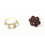 A yellow metal ladies' dress ring floral set with garnet-coloured stones,